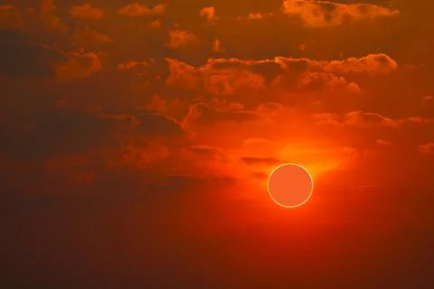 Phenomenon of partial sun eclipse over sea and sunset sky Stock Photos