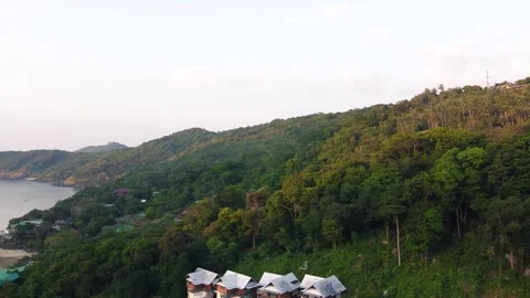 Phi Phi Don Beach, forest and homes at sunset, Thailand from drone Stock Footage 327930031