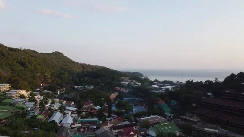 Phi Phi Don Beach, forest and homes at sunset, Thailand from drone Stock Footage 329218553