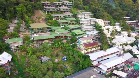 Phi Phi Don Beach, forest and homes at sunset, Thailand from drone 動画素材 332060390