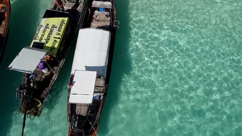 PHI PHI DON, THAILAND - DECEMBER 24, 2019: Aerial view of long tail boats a.. Stock Footage 334534993