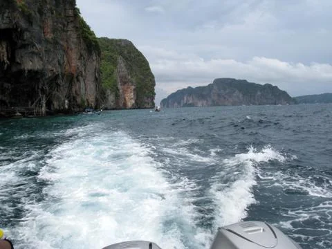 Phi phi island and cave in thailand with boat wake Stock Photos
