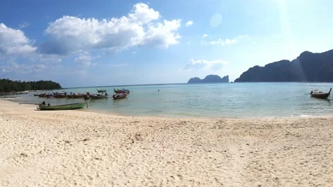 Phi Phi Island - December 15, 2019: Boats on water near white sand beach Stock Footage 150005000