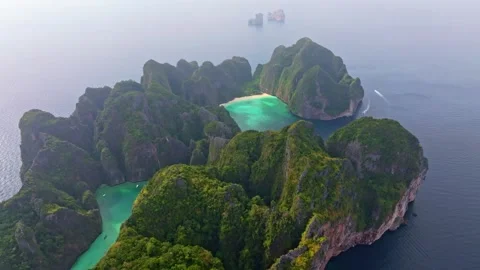 Phi Phi Lee island aerial showing Maya Bay and lush green cliffs Stock Footage 303357434