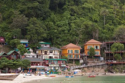 Phi Phi Thailand 12.6.2015 beachside buildings with tourists and boats Stock Photos