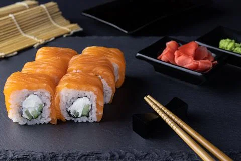 Philadelphia roll sushi with salmon, cucumber, cream cheese in focus Stock Photos