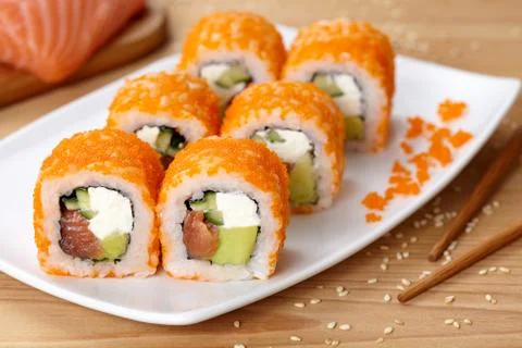 Philadelphia sushi roll with salmon, avocado, cream cheese, cucumber and tobiko Stock Photos