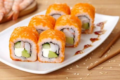Philadelphia sushi roll with shrimp, avocado, cream cheese, cucumber and tobiko Stock Photos