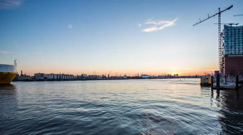 Philharmonic building and harbor with container ships in the evening timelapse Stock-Footage 50558316