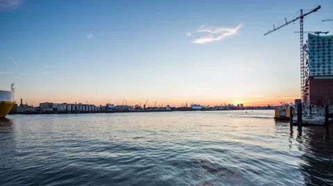 Philharmonic building and harbor with container ships in the evening timelapse Stock Footage 50559995