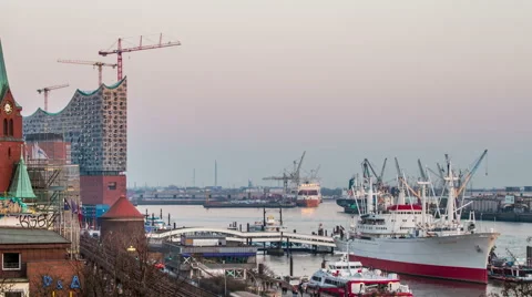 Philharmonic building and harbor with container ships, evening timelapse Stock Footage 50560513