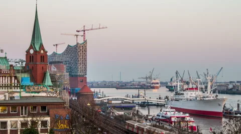 Philharmonic building and harbor with container ships in the evening timelapse Stock-Footage 50560523