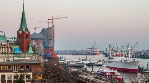 Philharmonic building and harbor with container ships in the evening timelapse Stock Footage 50561615