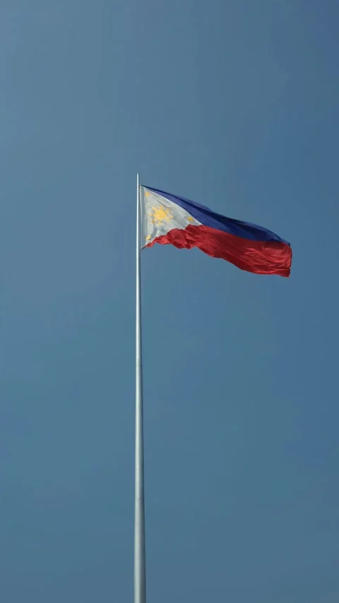 Philippine flag waving in the wind against a blue sky background. Stock Footage 300066636