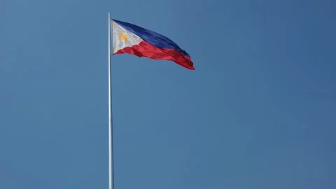 Philippine flag waving in the wind against a blue sky background. Stock Footage 300066641