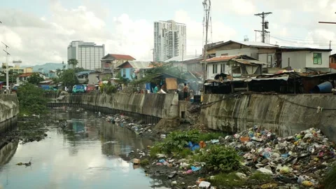 Philippine slum poor river garbage waste shanty landfill waste pollution Stock Footage 311640260