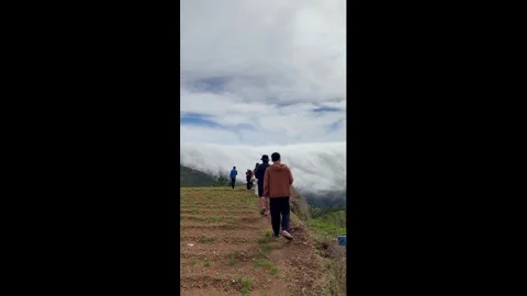 Philippines: Cloud waterfall tumbles over mountain ridge in the Philippin... Stock Footage 323796387