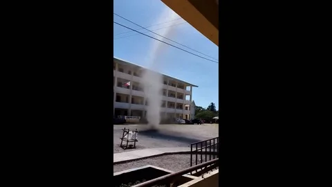 Philippines: Dust devil swirling on Cotabato school compound Stock Footage 277487933