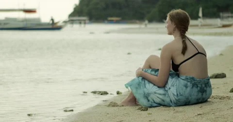 Philippines - Sitting on beach with kid picking shells Stock Footage 58940972
