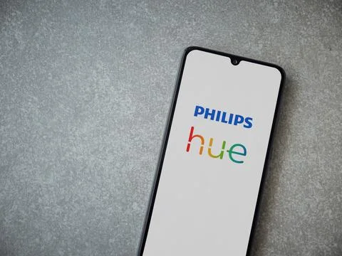 Philips Hue app launch screen on smartphone on ceramic stone background Stock Photos