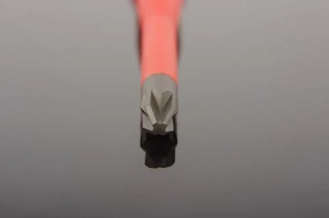 Philips screwdriver tip macro close up isolated on the black reflecting surfa Stock Photos