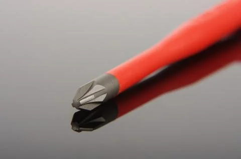 Philips screwdriver tip macro close up isolated on the black reflecting surfa Stock Photos