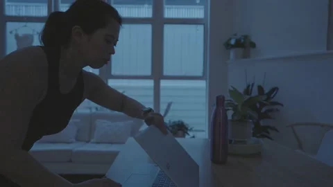 A Phillipino women opens up her computer to start an early morning workout Video stock 201231189