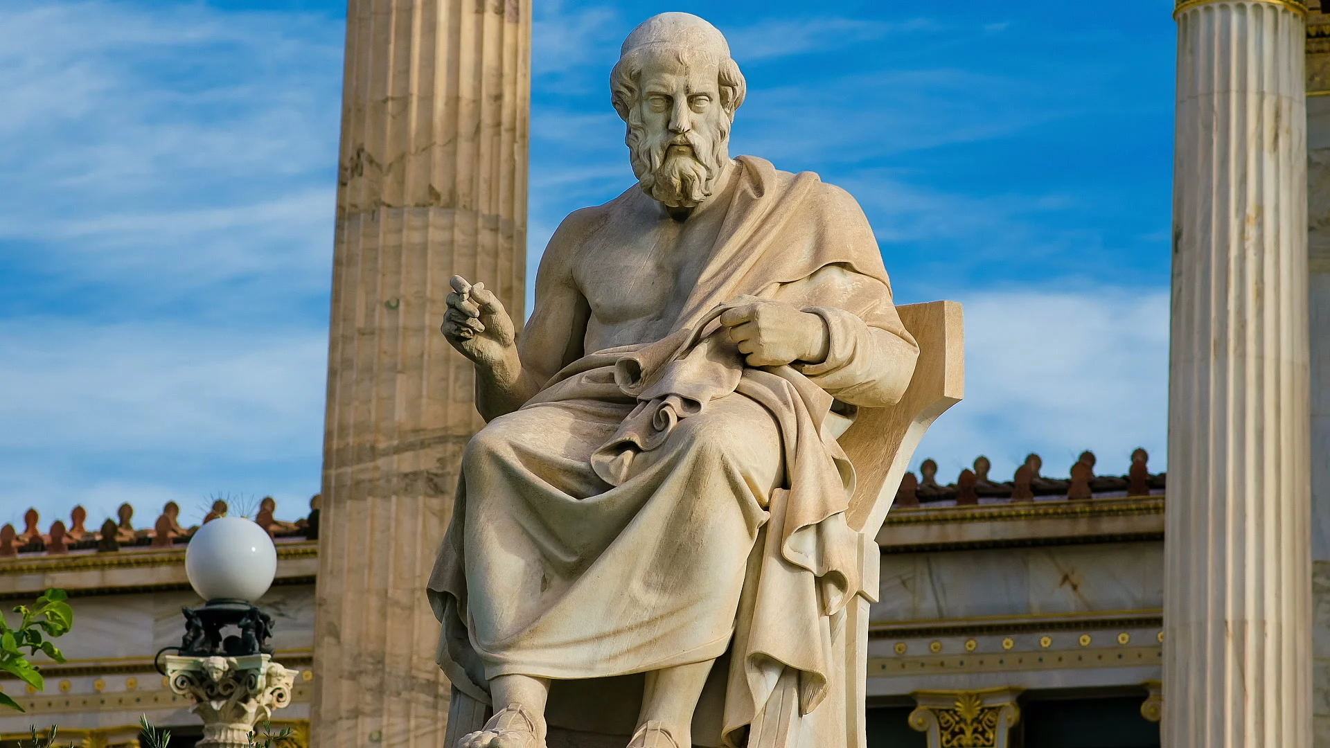 Philosopher Plato on a marble chair, background of sky and marble columns.