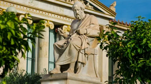 Philosopher Plato sitting on a marble chair, background of classical columns. Video stock 88323822