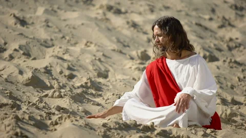 Philosopher pouring sand from hand in desert, reflecting on life and time Stock Footage 112648107