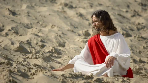 Philosopher pouring sand from hand in desert, reflecting on life and time Stock Footage 112654366