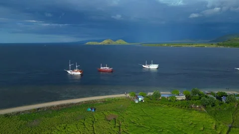 Phinisi boats navigating tropical bay with islands. Nice aerial view drone Stock Footage 344616495