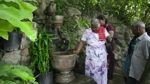 PHNOM PENH - JUNE 2012: indians wash hair with holy water Stock Footage 12170496