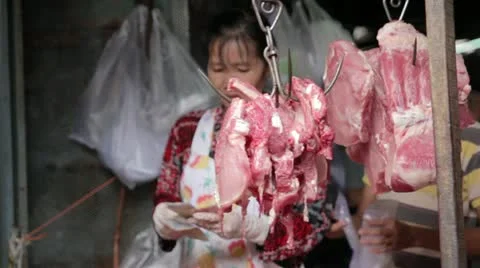 PHNOM PENH - JUNE 2012: local asian market butchers Stock Footage 12171986