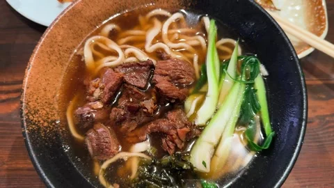 Pho bo is a Vietnamese dish made with rice noodles and beef. It is seasoned with Stock-Footage 320722456