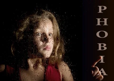 Phobia written on virtual screen. hand of frightened young girl melancholy and Stock Photos