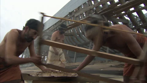 Phoenicians people using saw to cut wood - Reenactment Stock Footage 202914347
