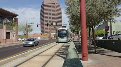 Phoenix light rail leaving red light and slowing for station Stock Footage 41590885