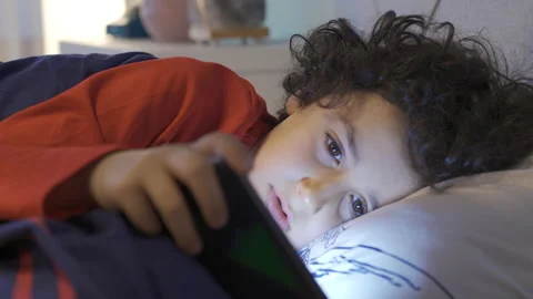 Phone addicted child is napping and continues to look at the phone. Stock Footage 227676709