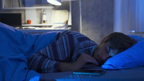 Phone addicted young man checking his phone even in his sleep. Stock Footage 222549828