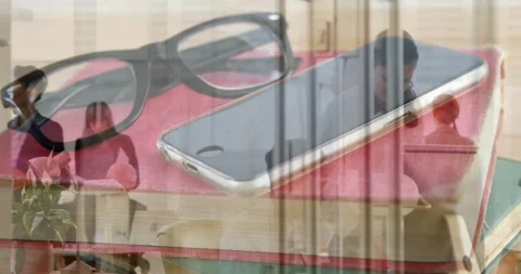 Phone and specs sitting on notes faint work meeting starting layering behind Stock Footage 334311869