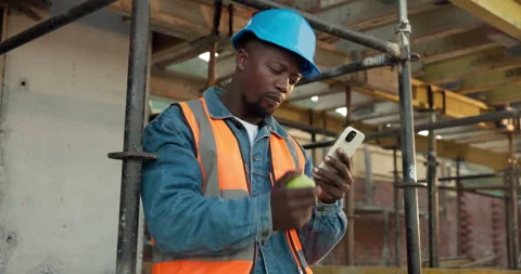 Phone, architect and black man with apple on construction site for lunch break Stock Footage 340636265