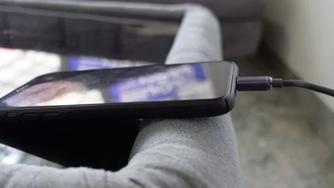The phone is being charged, connected to electricity Stock Footage 317624261