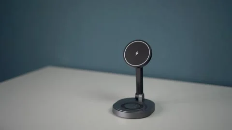 A phone with a black screen is removed from a magnetic stand with wireless Stock Footage 314465261