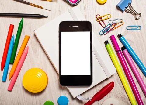 Phone with blank screen on table with office tools Stock Photos