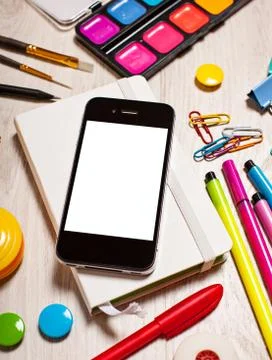 Phone with blank screen on table with office tools Stock Photos