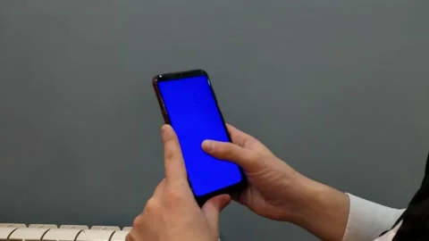 Phone with a blue screen, background for video and games, screen saver, man, Stock Footage 168472729