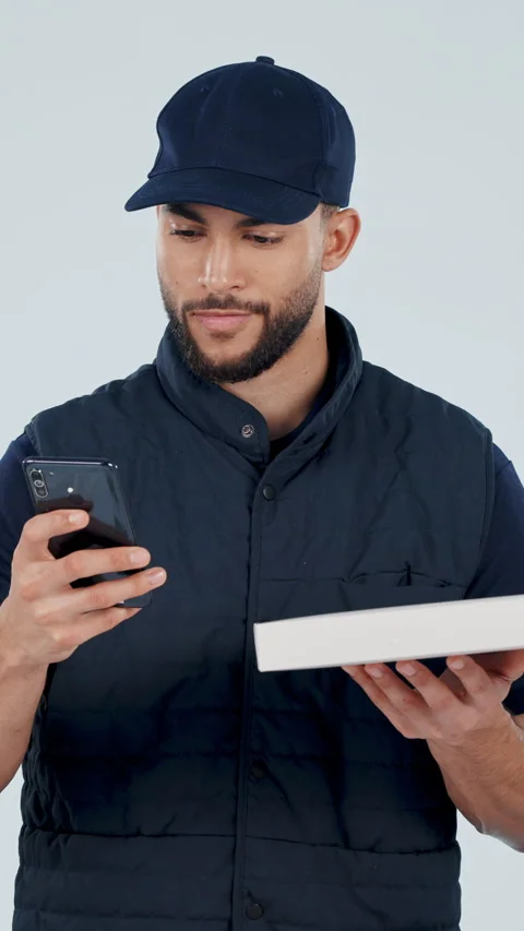 Phone, box and face of man with food delivery in studio with confirmation for Stock Footage 336842596