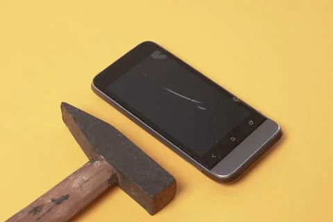 Phone broken with a hammer Stock Photos