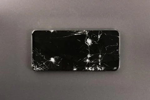 Phone with broken screen, cracks on the screen Foto stock